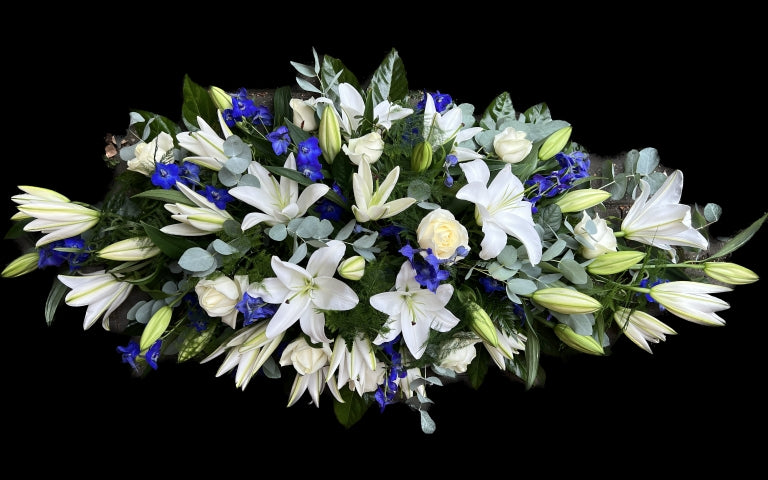 Lily rose and Delphinium casket spray