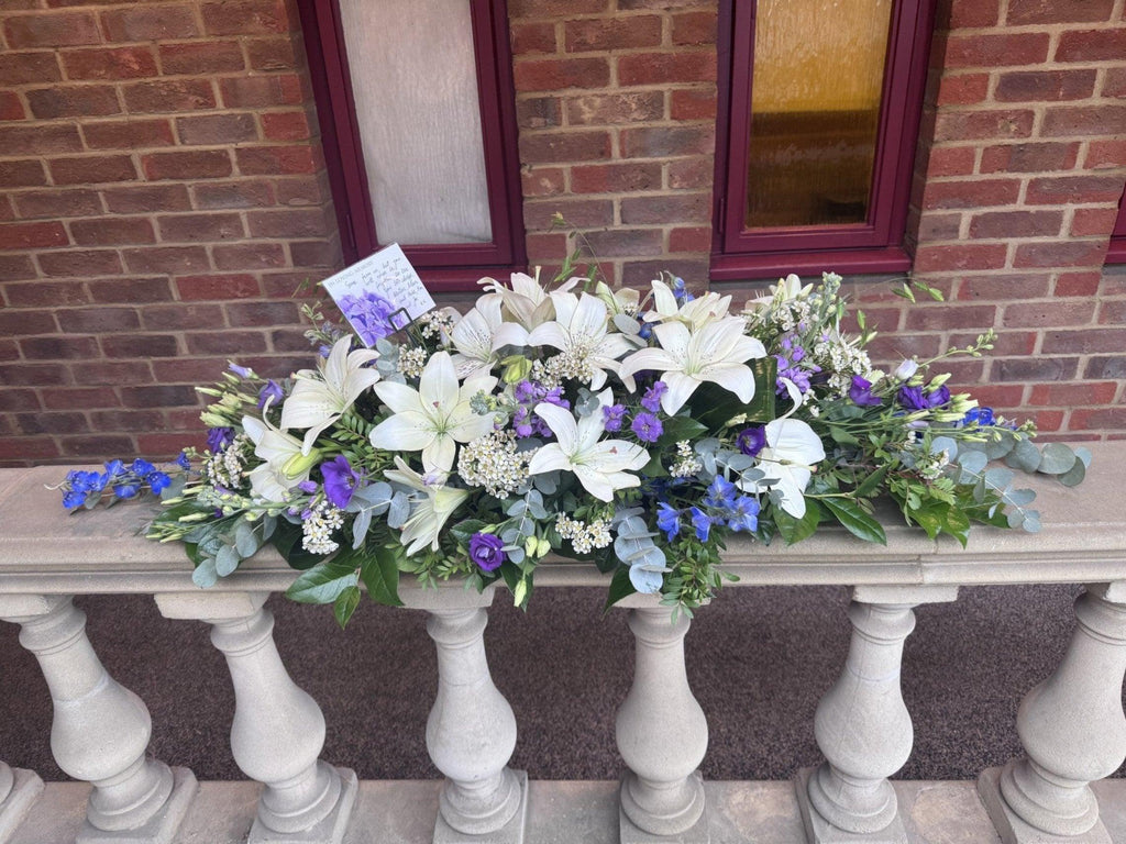 BLUE AND WHITE CASKET SPRAY - Rams florists