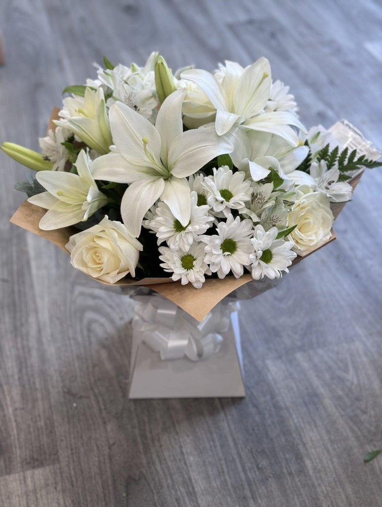 Sympathy hand tied made with the finest flowers. - Rams florists