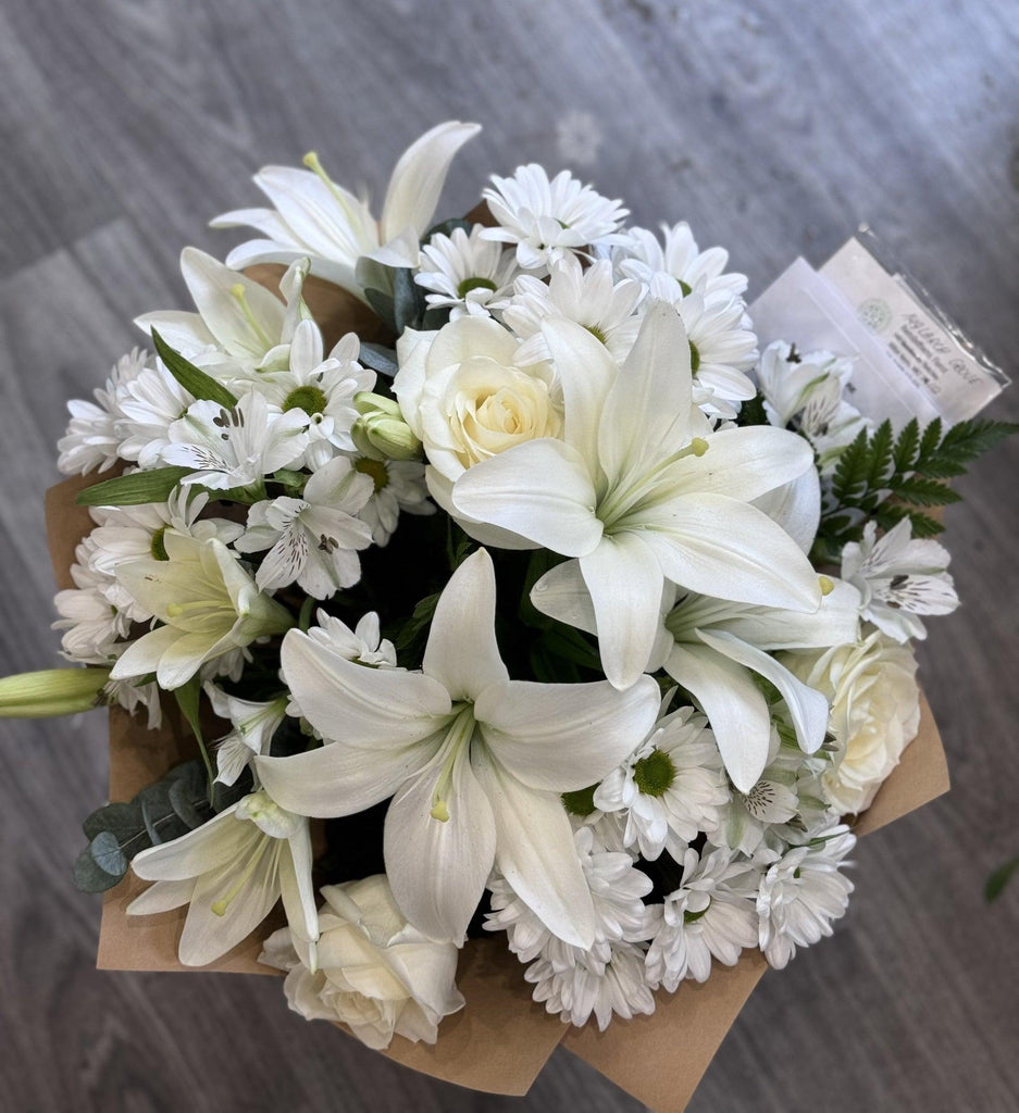 Sympathy hand tied made with the finest flowers. - Rams florists