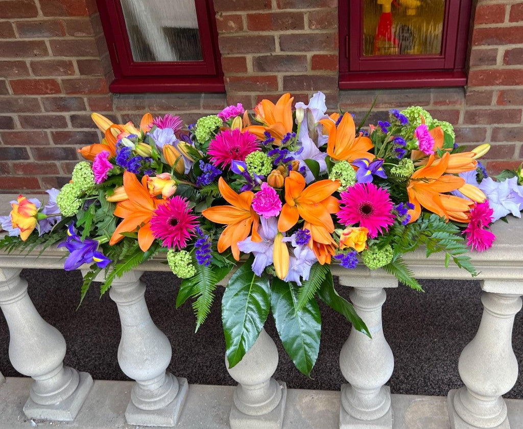 Vibrant Casket Spray - Rams florists